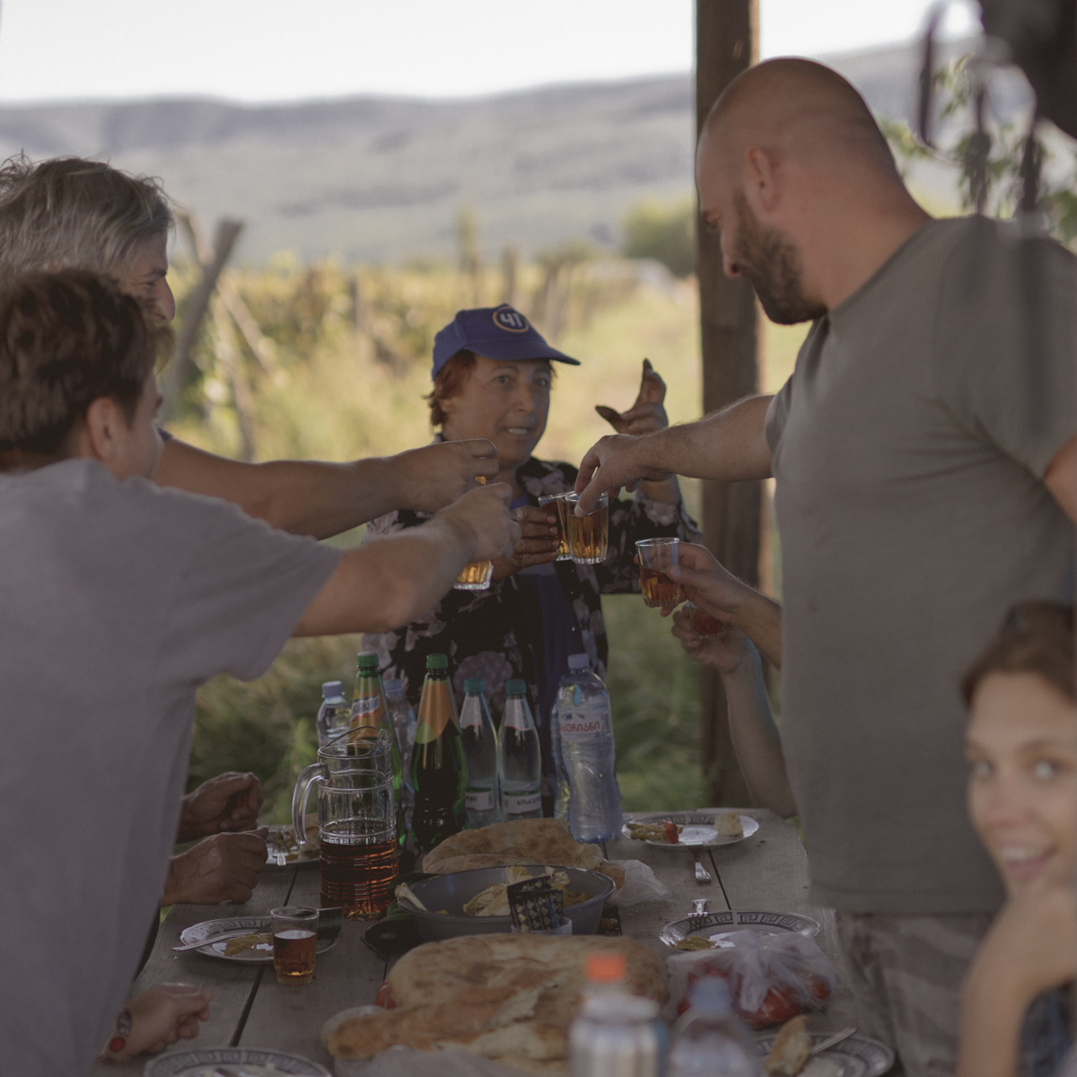 Wir trinken Orange Wein in einem Pavillon auf dem Feld nach der Weinernte 2021